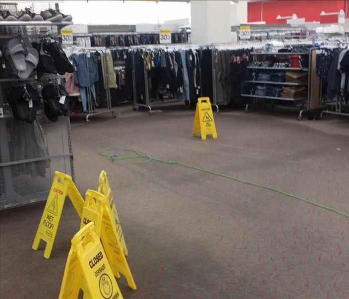 department store with wet carpet with wet carpet signs.